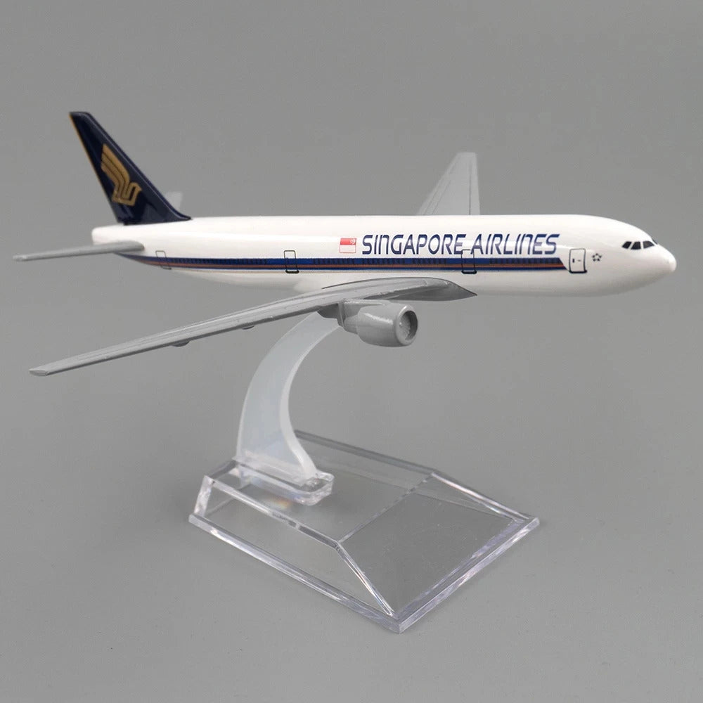 Model of a Singapore Airlines airplane on a clear stand against a gray background