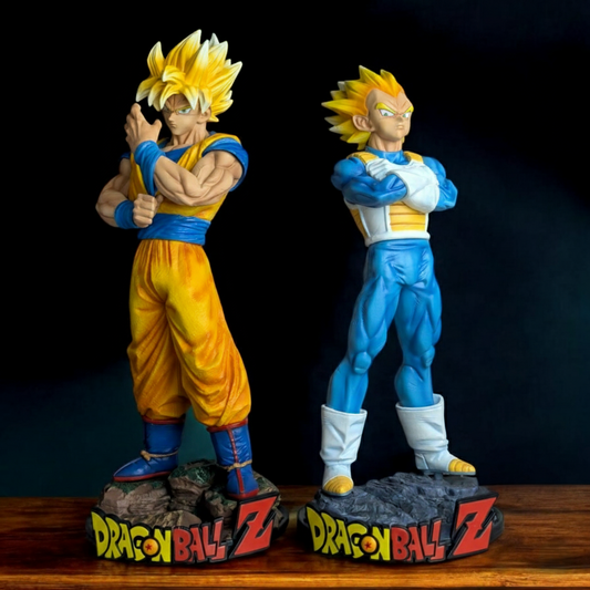 Set of 2 Dragon Ball Z Super Saiyan Goku and Super Saiyan Vegeta standing figures, 30-32.5 cm tall, on rocky bases with the DBZ logo. High-quality collectible statue set.