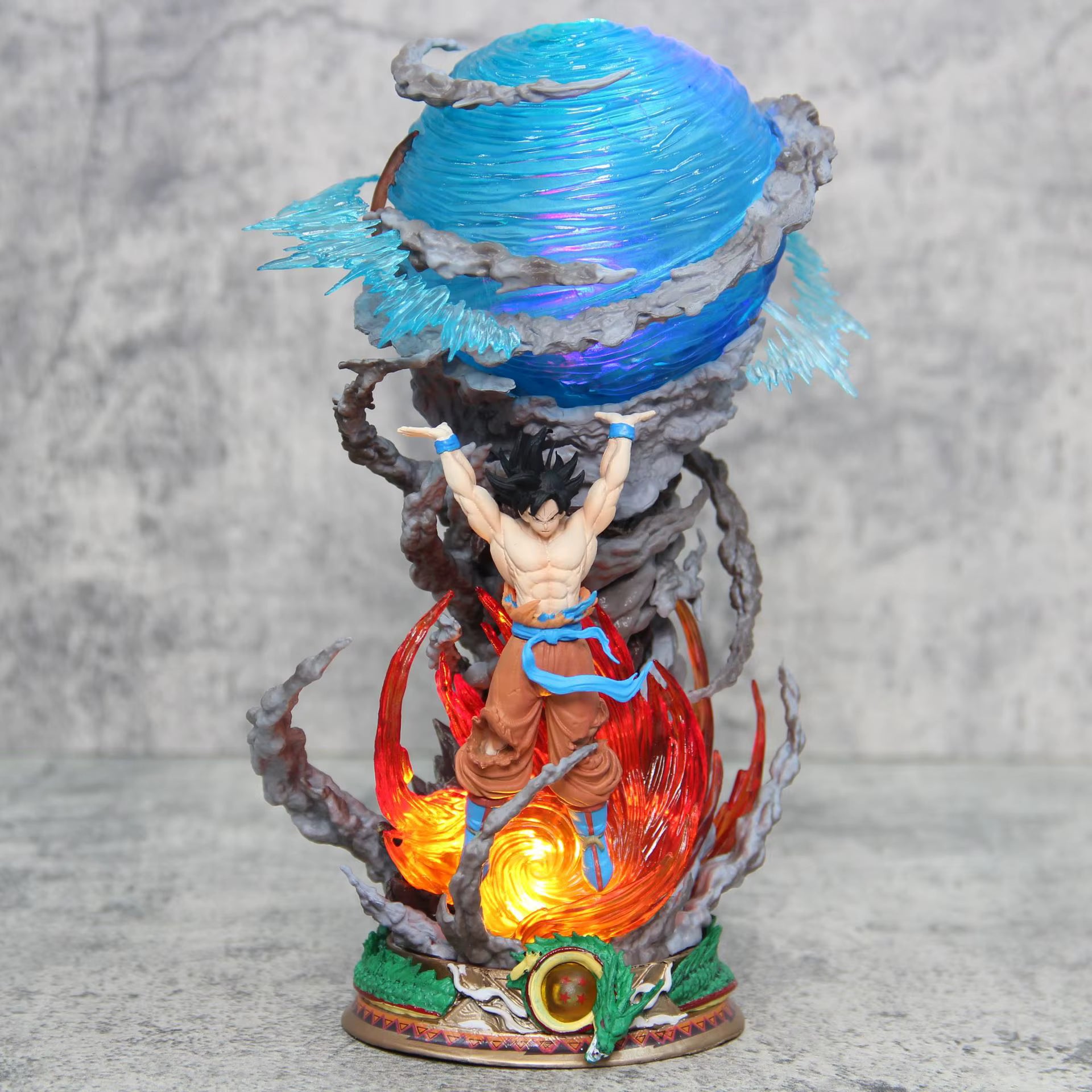 Dragon Ball Z Goku Spirit Bomb action figure 23 cm, illuminated blue Genki Dama and red fire base. Goku is raising his arms mid-power-up. High-quality collectible.