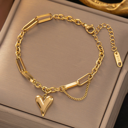 Amora gold plated mixed link heart charm bracelet resting inside a premium jewelry gift box