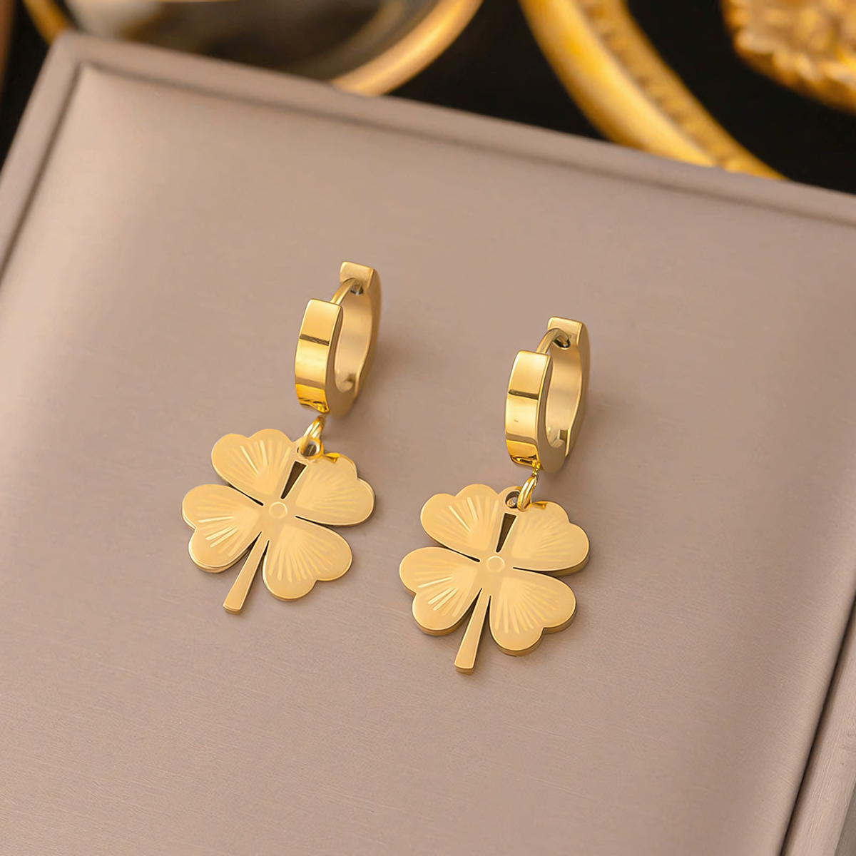 Ivy gold plated anti-tarnish clover huggie earrings displayed inside a premium jewelry gift box