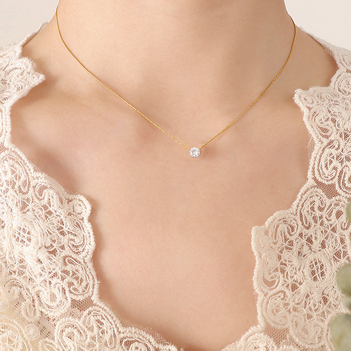 Model wearing the delicate Lumi gold anti-tarnish solitaire crystal necklace on collarbone