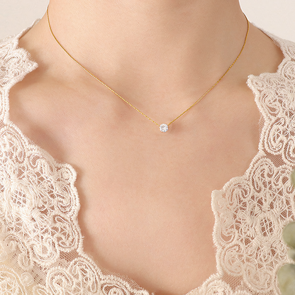 Model wearing the delicate Lumi gold anti-tarnish solitaire crystal necklace on collarbone