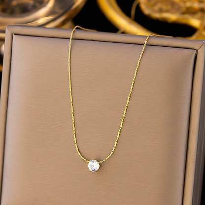 Lumi gold anti-tarnish solitaire necklace resting inside a premium jewelry gift box