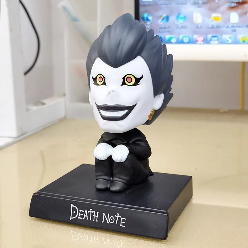 Death Note Ryuk bobble head toy figurine 10 cm, seated on a black base with the Death Note logo. High-quality Shinigami collectible toy.