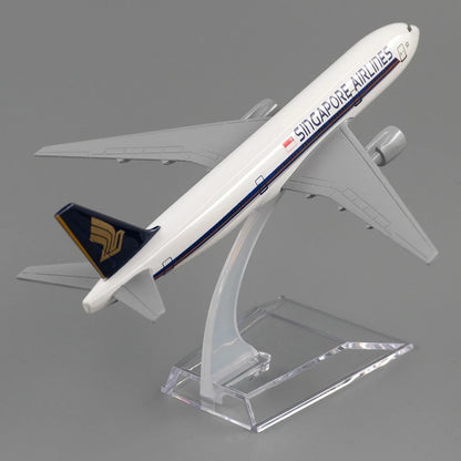 Model airplane of Singapore Airlines on a clear stand against a gray background