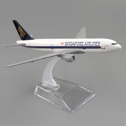 Model of a Singapore Airlines airplane on a clear stand against a gray background