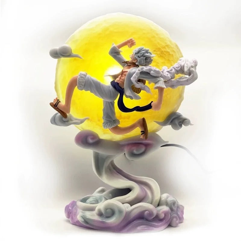 One Piece Luffy Gear 5 Sun God Nika figure 25 cm, leaping in front of a glowing yellow LED moon/sun on a swirling cloud base. High-detail anime statue.