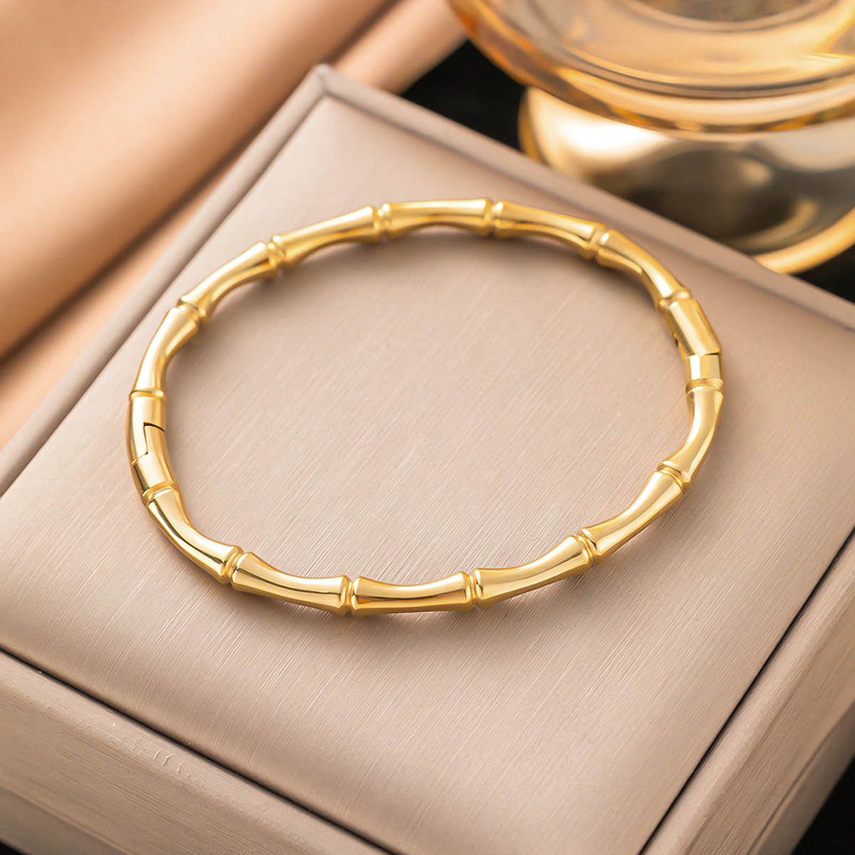 Mila gold plated anti-tarnish bamboo bracelet resting inside a premium jewelry gift box