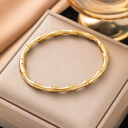 Mila gold plated anti-tarnish bamboo bracelet resting inside a premium jewelry gift box