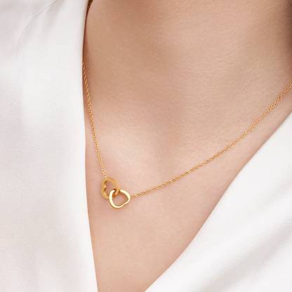 Model wearing the delicate Nova gold anti-tarnish interlocking hearts necklace on collarbone