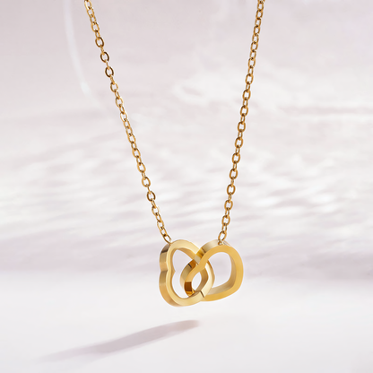 Close up of the Nova anti-tarnish gold double interlocking heart pendant and cable chain