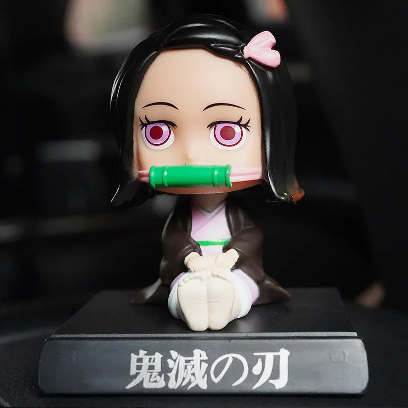 Demon Slayer Nezuko Kamado bobble head toy figurine 10 cm, seated with bamboo muzzle on a black display base. High-quality car dashboard collectible toy.