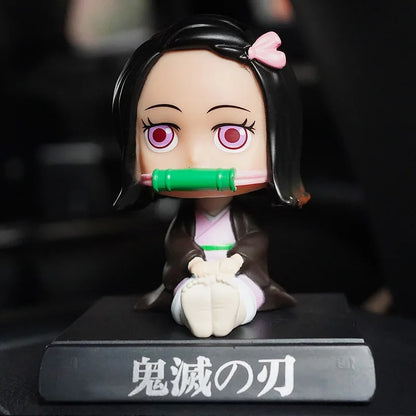 Demon Slayer Nezuko Kamado bobble head toy figurine 10 cm, seated with bamboo muzzle on a black display base. High-quality car dashboard collectible toy.